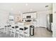Modern kitchen features stainless steel appliances and an island with seating at 38296 Sonnet Landing Ave, Zephyrhills, FL 33540