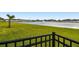 Scenic lake view with grassy area and fence at 38296 Sonnet Landing Ave, Zephyrhills, FL 33540