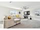 Spacious living room featuring a sectional sofa and fireplace at 38296 Sonnet Landing Ave, Zephyrhills, FL 33540