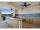Outdoor kitchen with granite counters and bar at 38296 Sonnet Landing Ave, Zephyrhills, FL 33540