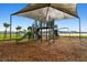 Modern playground equipment under shade at 38296 Sonnet Landing Ave, Zephyrhills, FL 33540