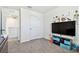 ' bedroom with TV, closet, and ample floor space at 38296 Sonnet Landing Ave, Zephyrhills, FL 33540