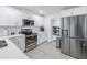 Modern kitchen with white cabinets, stainless steel appliances, and quartz countertops at 4104 W Marietta St, Tampa, FL 33616