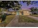 Tan ranch house with light teal shutters and a well-manicured lawn at 415 Country Club Dr, Oldsmar, FL 34677