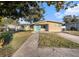 Ranch-style home with a spacious yard and a long driveway at 415 Country Club Dr, Oldsmar, FL 34677