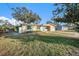 Single story home with a landscaped lawn at 415 Country Club Dr, Oldsmar, FL 34677