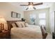 Cozy bedroom with a ceiling fan, neutral walls, and a comfortable bed with plush pillows and soft bedding at 4884 Yacht Club Dr, Tampa, FL 33616