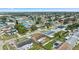 Aerial view of the property and surrounding neighborhood, near a body of water at 5147 Perennial Dr, Holiday, FL 34690