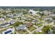 Aerial view of house and neighborhood, showcasing surrounding homes and lake at 5147 Perennial Dr, Holiday, FL 34690