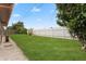 Large backyard with grassy lawn and wooden fence at 5147 Perennial Dr, Holiday, FL 34690