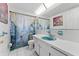 Clean bathroom with teal vanity and shower/tub combo at 5147 Perennial Dr, Holiday, FL 34690