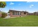 Back exterior view of the house and yard at 5147 Perennial Dr, Holiday, FL 34690