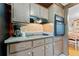 Kitchen detail showing cooktop, cabinets, and microwave at 5147 Perennial Dr, Holiday, FL 34690