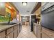 View of kitchen with stainless steel appliances and tile floors at 5147 Perennial Dr, Holiday, FL 34690