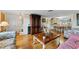 Living room with hardwood floors, sofa, and adjacent dining area at 5147 Perennial Dr, Holiday, FL 34690