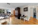 Bright living room with hardwood floors, comfy sofa, and large window at 5147 Perennial Dr, Holiday, FL 34690