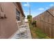 Side yard with rocking chairs and a wooden fence at 5147 Perennial Dr, Holiday, FL 34690
