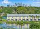 Exterior view of waterfront townhouses with city skyline in the distance at 5215 Coquina Key Se Dr # A, St Petersburg, FL 33705