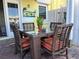 Enjoy outdoor dining on this patio, featuring a glass-top table and wicker chairs at 5215 Coquina Key Se Dr # A, St Petersburg, FL 33705