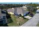 Aerial view of house with screened patio and landscaping at 5320 Golden Isles Dr, Apollo Beach, FL 33572
