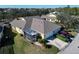 Aerial view of house with screened patio and landscaping at 5320 Golden Isles Dr, Apollo Beach, FL 33572