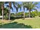 Outdoor basketball court with palm trees and lush landscaping at 5320 Golden Isles Dr, Apollo Beach, FL 33572