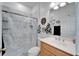 Clean bathroom with a walk-in shower and wood vanity at 5320 Golden Isles Dr, Apollo Beach, FL 33572