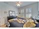 Bright bedroom with plantation shutters and a floral comforter at 5320 Golden Isles Dr, Apollo Beach, FL 33572