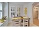 Charming breakfast nook with yellow table runner and white chairs at 5320 Golden Isles Dr, Apollo Beach, FL 33572