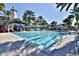 Resort-style pool with lap lanes, water slide, and palm trees at 5320 Golden Isles Dr, Apollo Beach, FL 33572