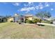 House with a screened patio and well-maintained lawn at 5320 Golden Isles Dr, Apollo Beach, FL 33572