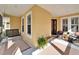 Front porch with swing and seating area at 5320 Golden Isles Dr, Apollo Beach, FL 33572