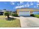 House with a two car garage and landscaping at 5320 Golden Isles Dr, Apollo Beach, FL 33572