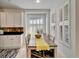 Bright kitchen features white cabinets, granite countertops, and a breakfast nook at 5320 Golden Isles Dr, Apollo Beach, FL 33572