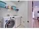 Laundry room with washer, dryer, and shelving at 5320 Golden Isles Dr, Apollo Beach, FL 33572