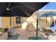 Relaxing patio with brick pavers, umbrellas, and seating area at 5320 Golden Isles Dr, Apollo Beach, FL 33572