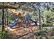 Shaded playground with slides, climbing structures, and wood chips at 5320 Golden Isles Dr, Apollo Beach, FL 33572