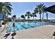 Large, resort-style pool with palm trees and plenty of lounge space at 5320 Golden Isles Dr, Apollo Beach, FL 33572