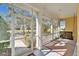 Screened porch with a swing and view of the backyard at 5320 Golden Isles Dr, Apollo Beach, FL 33572