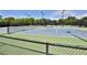 Well-maintained tennis courts with shade structure at 5320 Golden Isles Dr, Apollo Beach, FL 33572