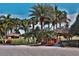 Lush landscaping with palm trees and thatched gazebos at 5320 Golden Isles Dr, Apollo Beach, FL 33572