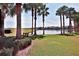Serene waterfront view with palm trees and bench at 5320 Golden Isles Dr, Apollo Beach, FL 33572