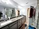 Modern bathroom with double vanity and walk-in shower at 5508 Viola Lee Way, Lutz, FL 33558