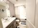 Clean bathroom with a tub shower combo, vanity, and toilet at 5508 Viola Lee Way, Lutz, FL 33558