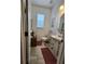 Clean bathroom with pedestal sink, toilet and tile floor at 5508 Viola Lee Way, Lutz, FL 33558