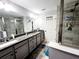 Modern bathroom with double vanity and walk-in shower at 5508 Viola Lee Way, Lutz, FL 33558