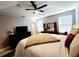 Spacious bedroom with a large bed and ceiling fan at 5508 Viola Lee Way, Lutz, FL 33558