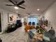 Open dining area with glass table and orange chairs at 5508 Viola Lee Way, Lutz, FL 33558