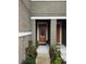 Front entrance with orange door and landscaping at 5508 Viola Lee Way, Lutz, FL 33558