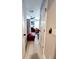 Hallway with light walls and wood-look flooring, leading to bedrooms at 5508 Viola Lee Way, Lutz, FL 33558